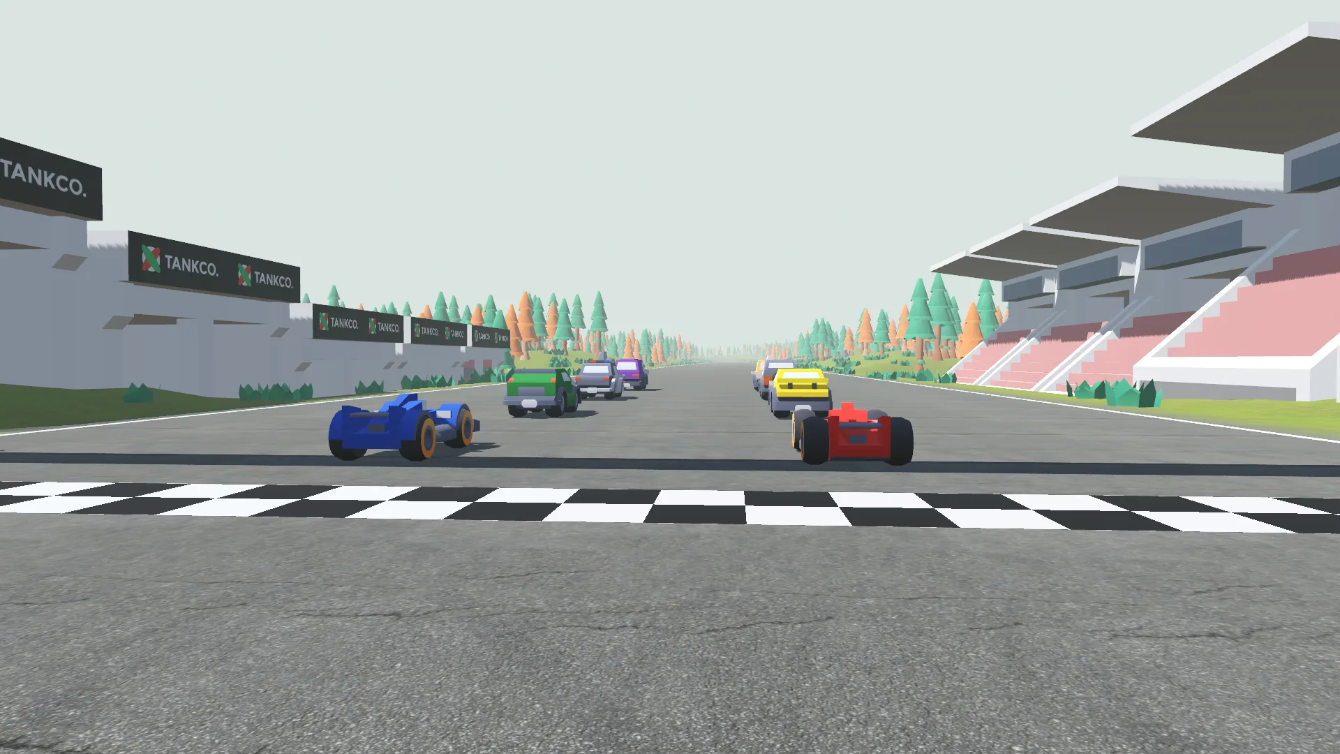 Eight cars lined up on the starting grid under a checkered gantry, grandstands on the right